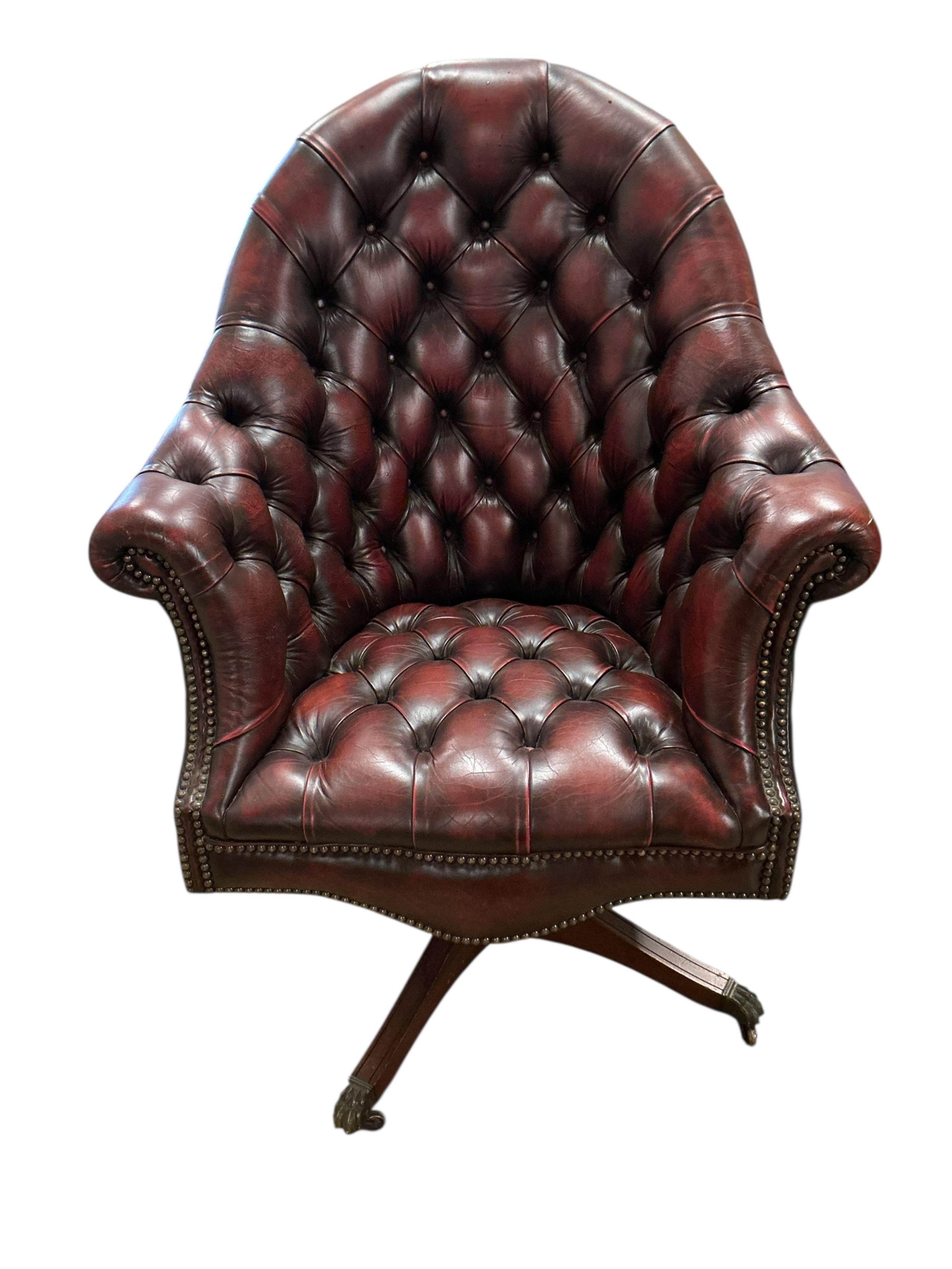 A reproduction buttoned burgundy leather swivel desk chair, width 80cm, depth 70cm, height 110cm